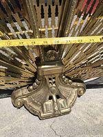 Close-up of the base showing detailed design and a measuring tape indicating about 21 inches in width.