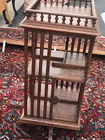 Side view showing vertical slats and open shelves of rotating cabinet