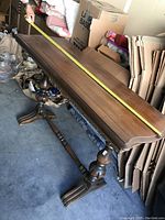 Full length of the wood hall table with tape measure showing approximately 52 inches length