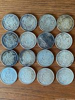 Reverse sides of 16 Canadian half dollars showing the Canadian coat of arms on each coin.