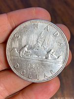 Obverse side of the coin showing a canoe with two paddlers and the inscriptions relevant to Canada and the coin's denomination and year.