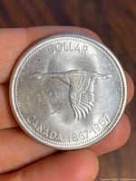 Reverse side of the coin showing flying goose and commemorative dates 1867-1967.