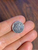 Front side of the silver coin dated 1872 showing Queen Victoria seated and inscription 'VICTORIA REGINA 1872'.