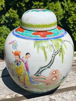 Front and side views of the antique hand painted and enamelled porcelain ginger jar, showing the detailed traditional Chinese figures, foliage, and colorful enamel decoration on the body.