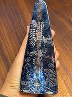 Top-down angled view showing carved white nature-inspired design, birds, foliage patterns, and Kosta Boda Sweden signature on the base.