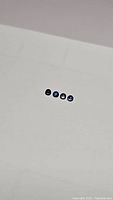 Five blue sapphire round cabochons on white background showing size and luster