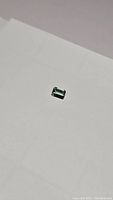 Another view of the mint green emerald cut tourmaline gemstone, emphasizing its color and luster.