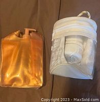 Two zippered carry cases holding Mary Kay Satin Hands products, one gold and one clear/white.