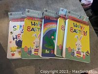 Set of 5 thick spiral notebooks with colorful Easter and spring covers, neatly stacked and displayed