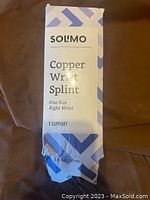 Box front showing Solimo branding and product name Copper Wrist Splint for one size right wrist support.
