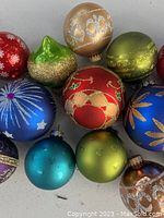 Close-up of assorted Christmas ball ornaments in various colors and decorative finishes
