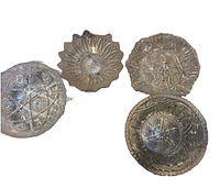 Four vintage glass bowls and platters arranged, showing detailed pressed glass patterns including starburst, floral, and geometric designs.