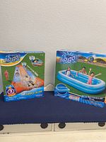 Boxes of new in box 8ft Blue Rectangular Inflatable Pool and 18ft Triple Water Slide by Bestway H2OGO brand.