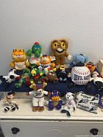 Wide view of all assorted stuff animals on a table surface.