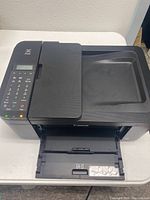 Front angle of the Canon PIXMA TR4522 printer showing paper output tray and scanner lid closed.