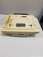 Top and side view of the off-white/beige Sony kitchen CD player with visible discoloration and handle.