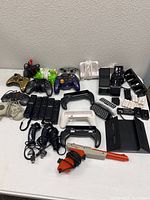 Overview of all controllers, charging stations, and accessories arranged on a flat surface showing color and variety.