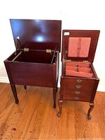 Open end table showing hinged top and empty internal space with removable hanging rods.