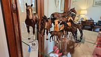 Shelf overview showing all five horse figurines