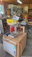 Mastercraft 13-inch drill press on wooden stand in workshop environment.