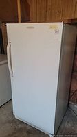 Front view of white upright freezer showing full exterior condition