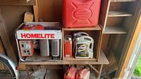 Overall view of generator, fuel cans, oil jug on shelf