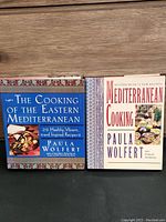 Pair of Paula Wolfert Mediterranean cooking hardcover books placed upright showing front covers.