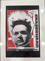 Framed Eraserhead movie poster with black and white image of character, red background and promotional text details.