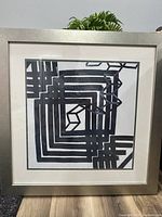 Abstract black and white geometric print framed in silver frame