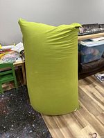 Front view of large green Yogibo bean bag chair, upright position showing overall shape and color.