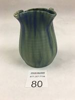 Front angled view showing blue and green matte glaze with drip effect on irregular shaped four-spout vase