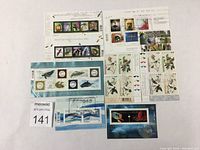 Eight souvenir sheets or inscription blocks showing animal, insect, and bird themed Canadian stamps in mixed used condition.