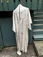 Full-length image showing the cream-colored kimono hanging, displaying the overall shape and length.
