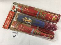 Three large bundles of long incense sticks from Thailand with traditional colorful packaging and two smaller packages including the orange box from India.