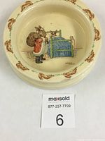Top view of ceramic bowl showing Santa Claus, bunnies in bed illustration with decorative bunny pattern around rim and maxsold lot card