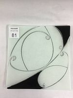 Top view of square fused glass platter showing clear glass with abstract swirl lines and black and white powder areas.