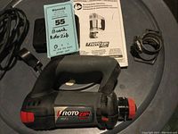 Bosch RotoZip RZ5 rotary tool with power cord and parts on a surface