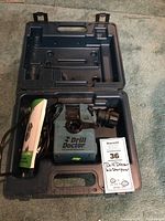 Drill Doctor 500 sharpener and components inside open hard plastic case on carpet