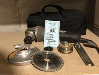 Porter Cable electric grinder with multiple attachments and carrying case on a flat surface.