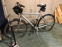 Side view of Trek 7000 bicycle with fenders, bags and floor pump leaning against frame