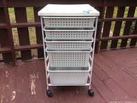 Front view of the utility cart showing five plastic drawers on caster wheels.