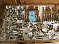 Full drawer view showing the complete Wallace flatware set including multiple spoons, forks, knives, and extra serving pieces neatly arranged.
