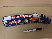 Side view of Kellogg's Racing branded diecast tractor-trailer with Tony Stewart #5 and racing decals with Sharpie marker for scale.