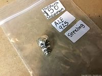 Image of a Pandora snowman charm in a plastic bag with labels indicating 'Pandora 925 Snowman', 'ALE 925', and 'Sterling'.