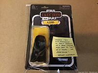 Front view of carded Kylo Ren cowl in original sealed packaging with Star Wars The Last Jedi branding and Kenner logo.