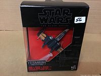 Front view of unopened Star Wars Black Series Titanium X-Wing die-cast model in original packaging with clear display and black box with Star Wars branding.