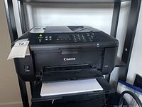 Front view of Canon PIXMA MX472 wireless inkjet printer with paper loaded in tray.