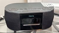 Front view of iHome iBT38 bedside alarm clock showing digital clock display and speaker fabric covering.
