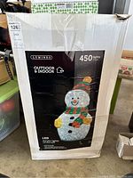 Box showing full product packaging with image of lighted snowman and Lumineo brand details.