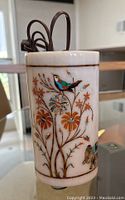 Photo showing cylindrical white marble vase lamp with colorful bird and flower inlay and power cord on top.
